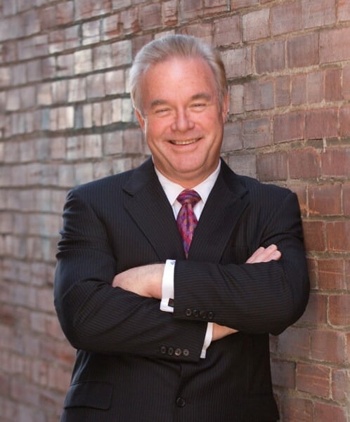 A photo of Robert, a smiling man in a suit.